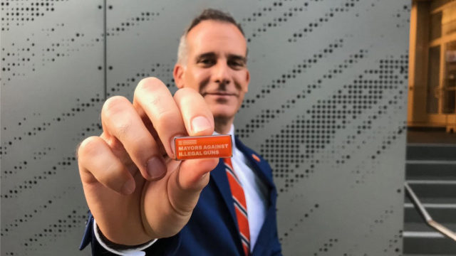 A mayor shows off his Mayors Against Illegal Guns pin