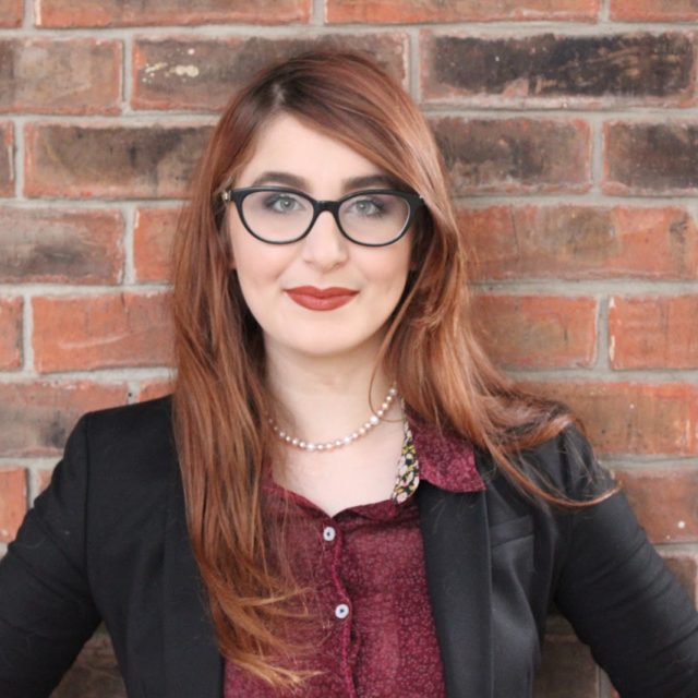 Mariam El-Haj stands in front of a brick wall