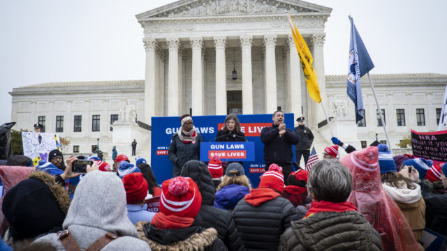 A rally of Moms Demand Action volunteers in front of the Supreme Court