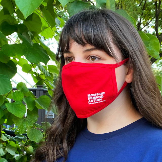 A woman wears a Moms Demand Action mask